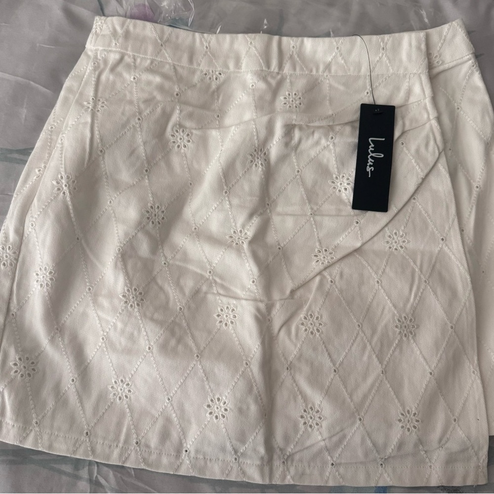 Truly Lovable Ivory Eyelet Embroidered Wrap Mini Skirt
Color: Ivory size S